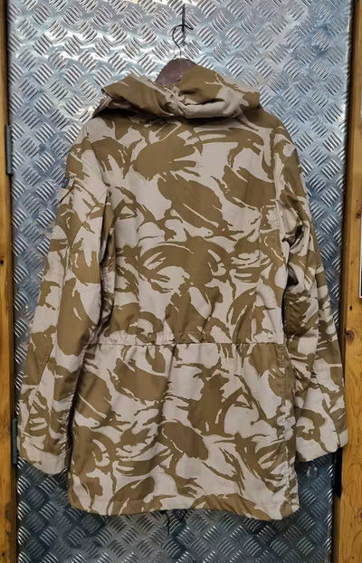 Camouflage-patterned jacket on a hanger against a metallic background