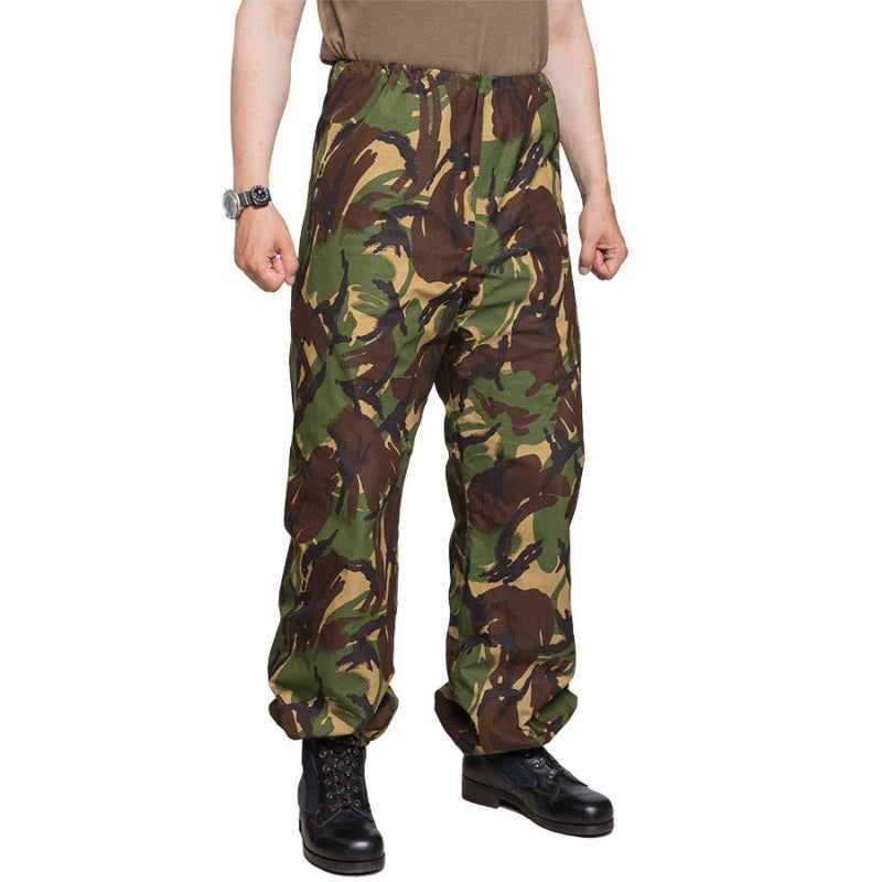 Camouflage pants worn by a person on a white background