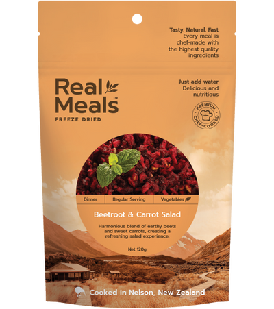 Packaging of Real Meals Freeze Dried Dinner Beetroot & Carrot Salad, with an image of the salad and a mint leaf, against a background of a landscape and mountains.