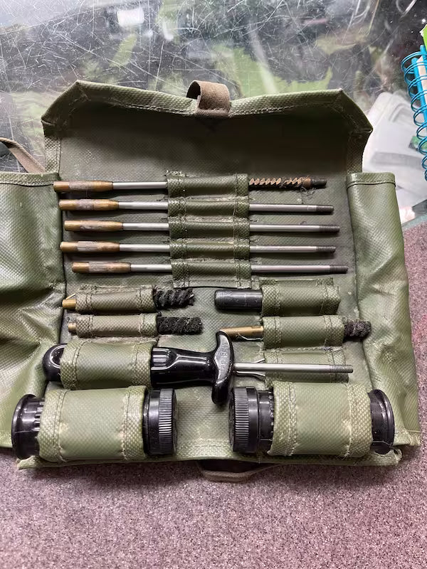 Set of tools in a green case on a textured surface