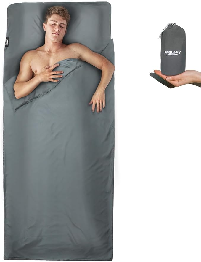 Person lying on a gray sleeping bag with a carrying case displayed.