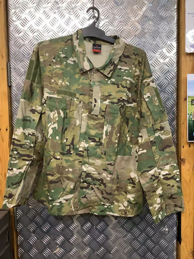Camouflage shirt on a hanger against a metallic wall.