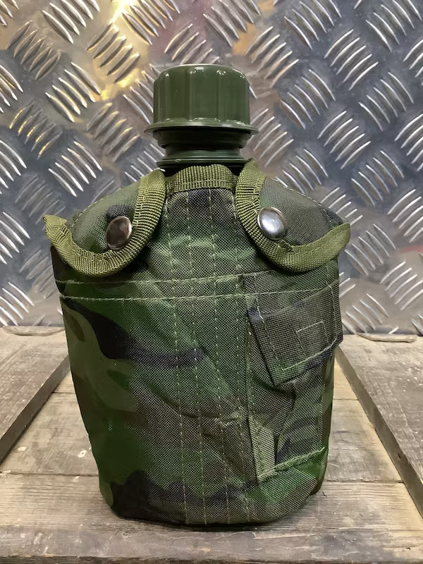 Green camouflage canteen on a metal and wooden surface