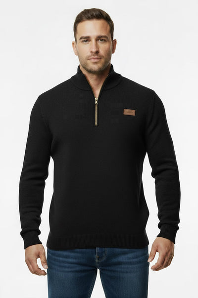 Man wearing a black zip-up sweater with a brown patch on a white background
