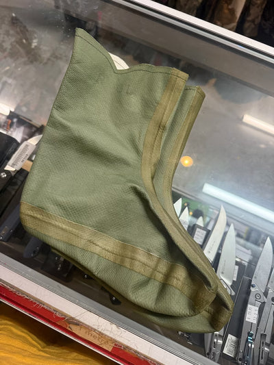 Green fabric bag on a glass surface with tools in the background