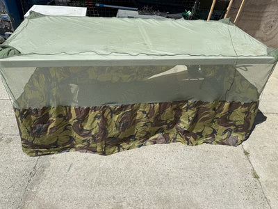 Camouflage-patterned tarp on a concrete surface