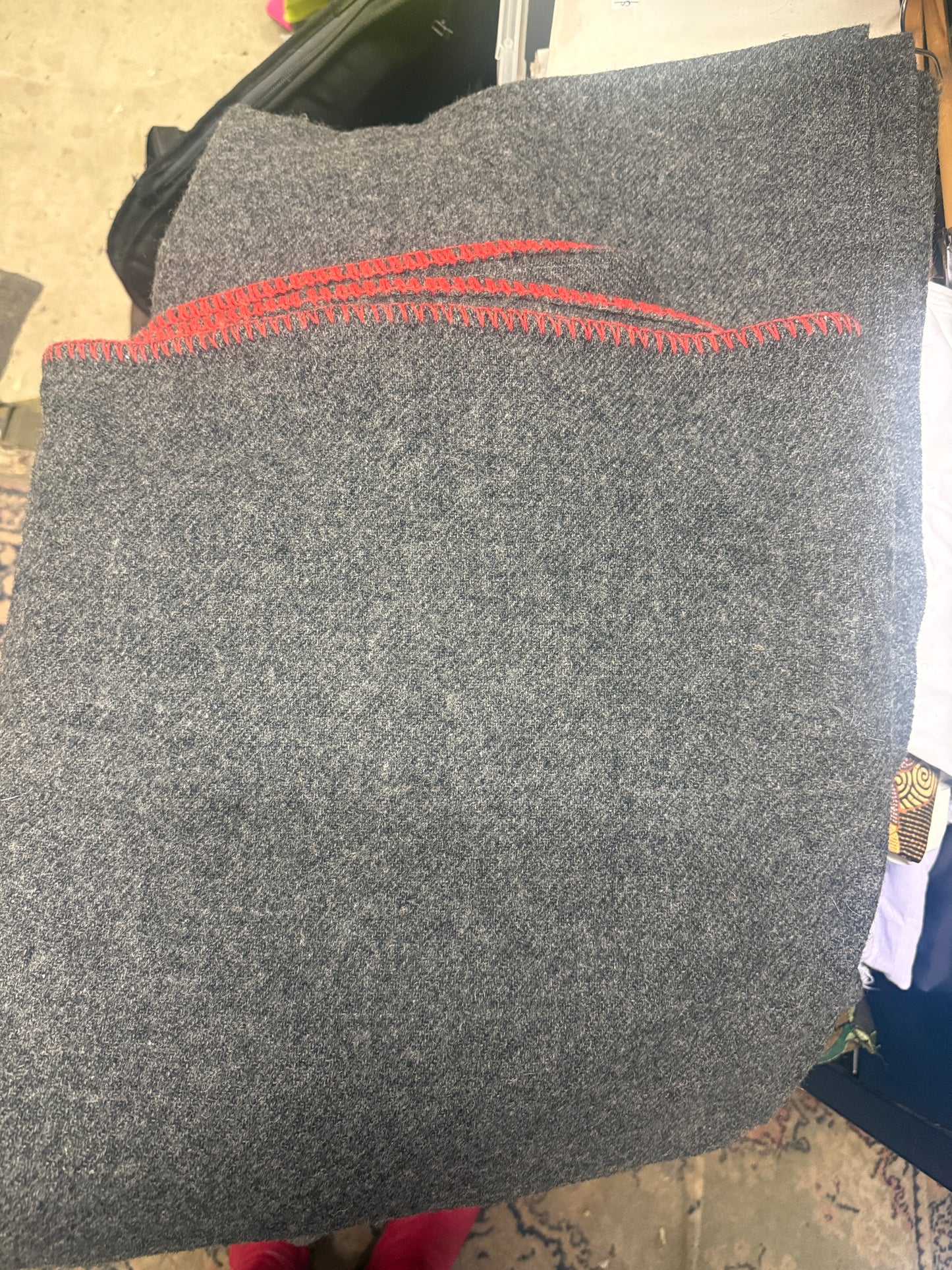 Grey Wool blanket with red stitching