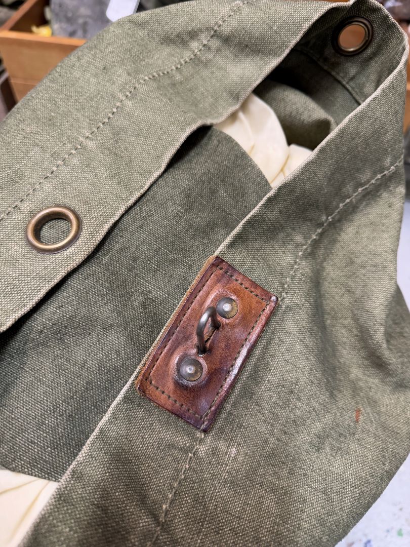 Close-up of a green fabric with leather patch and metal button