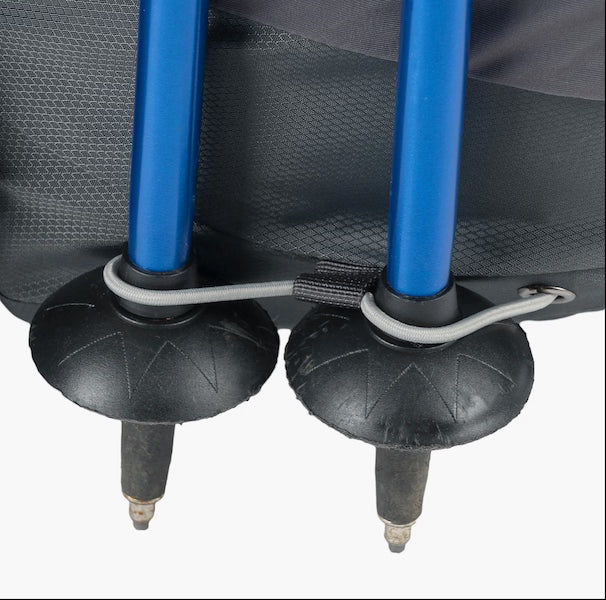 Close-up of blue trekking pole ends with black rubber feet on a backpack, on a white background