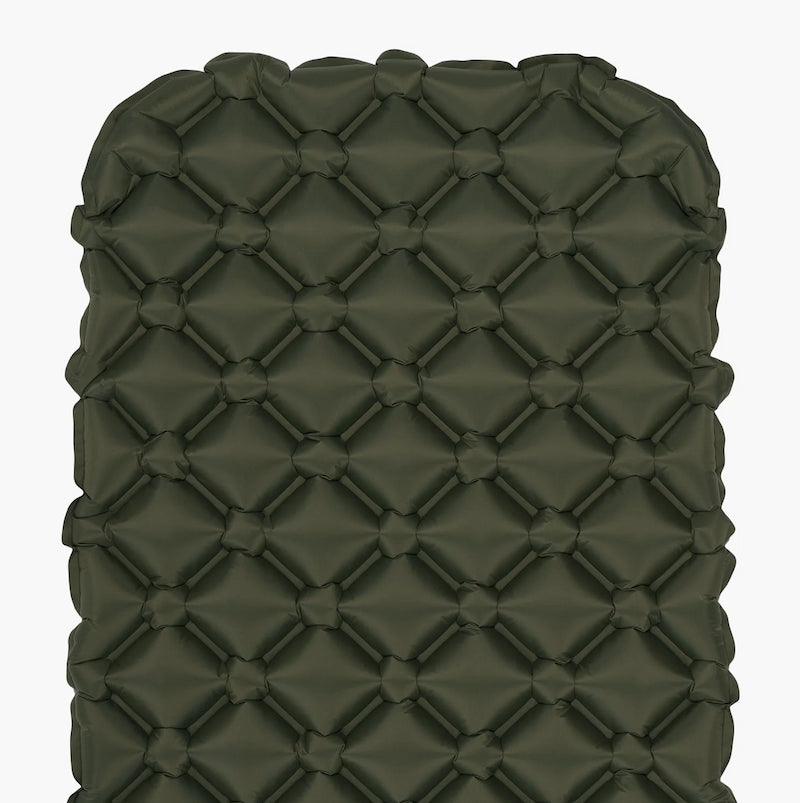Green quilted cushion on a white background