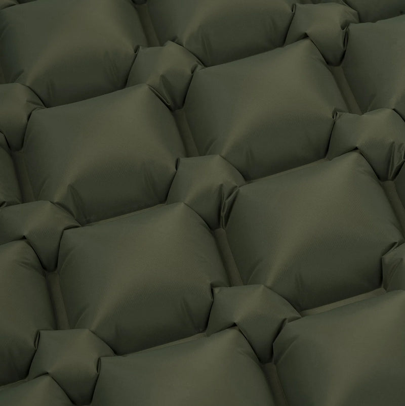 Dark green quilted pillows arranged in a pattern