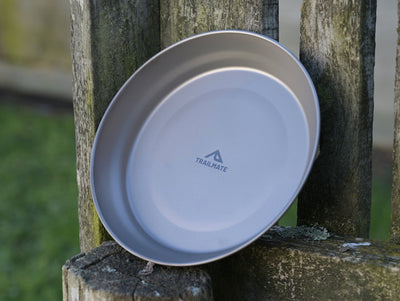 Two gray plates leaning against a wooden post with 'Trailmate' branding.