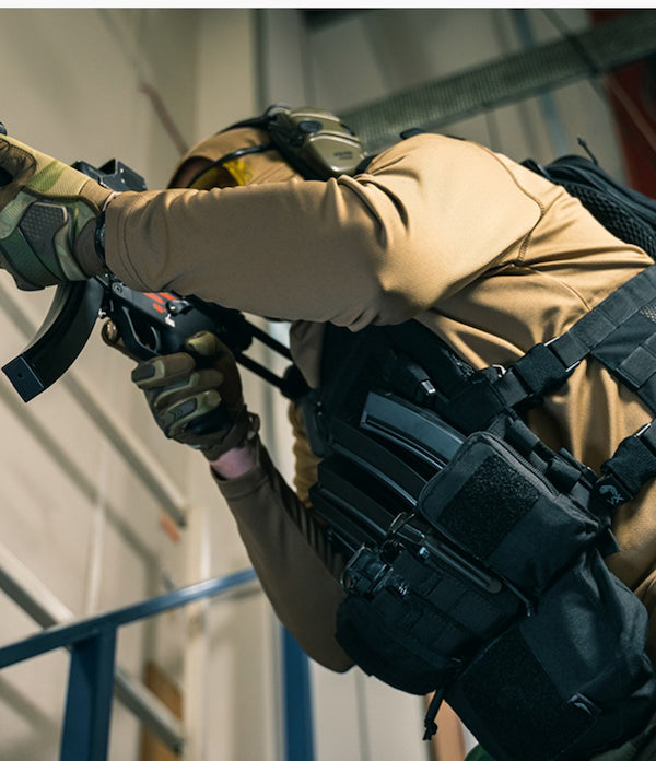 Person in tactical gear holding a weapon indoors