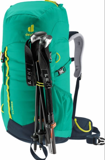 Green hiking backpack with Leki trekking poles on a white background