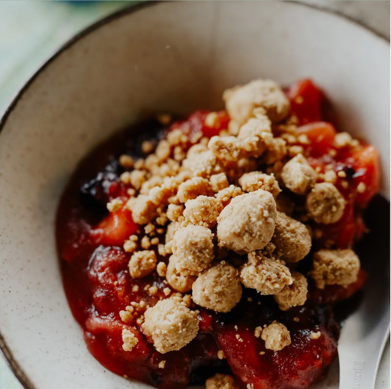 Close-up of a dessert with crumble topping in a bowl