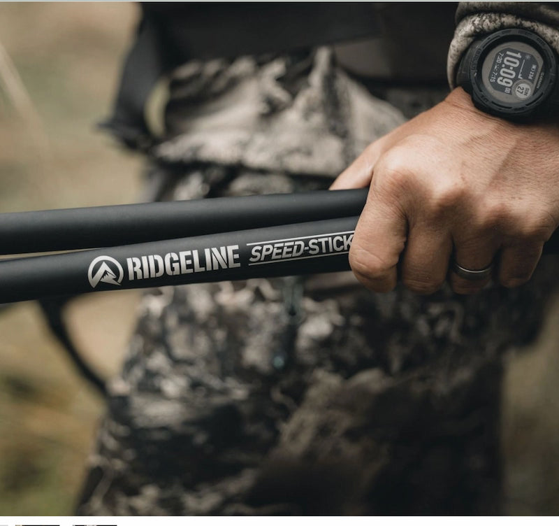 Hand holding a Ridgeline Speed Stick stick in a natural setting