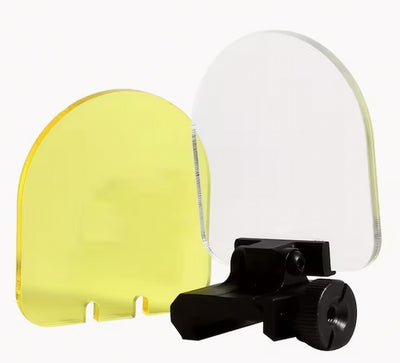 Yellow and clear visors with a black mounting bracket on a white background