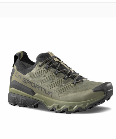 Green hiking shoe with black sole on a white background