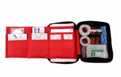 First aid kit with various supplies on a white background