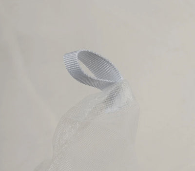White mesh ribbon on a light gray background