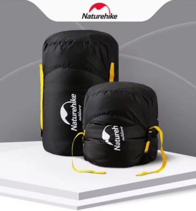 Two black sleeping bag compression sacks with yellow straps, one larger and one smaller, displayed against a white background with the Naturehike logo.