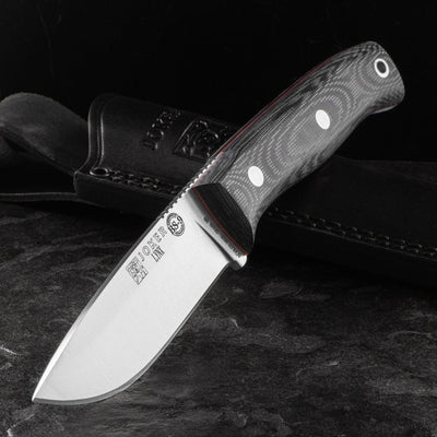 Knife with a wooden handle on a dark background