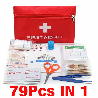 A red nylon zipped pouch labeled 'FIRST AID KIT' opened to display its contents including medical supplies and a pair of scissors.