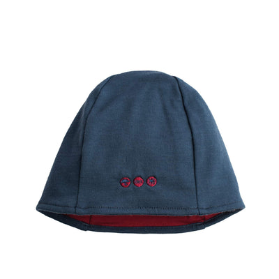 A reversible 100% New Zealand Merino Beanie in navy blue with a red interior, displayed on a plain background.