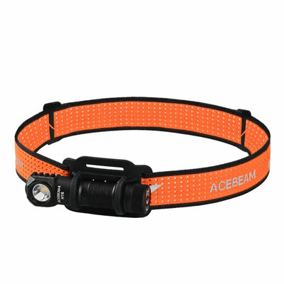 Orange headlamp with black flashlight on a white background