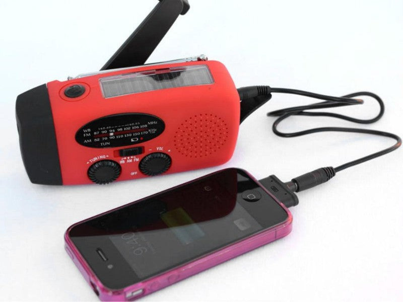 Red portable radio with a phone connected on a white background