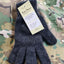 Pair of dark gray gloves with a tag on a camouflage background