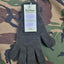 Pair of dark gray gloves with a tag on a camouflage background