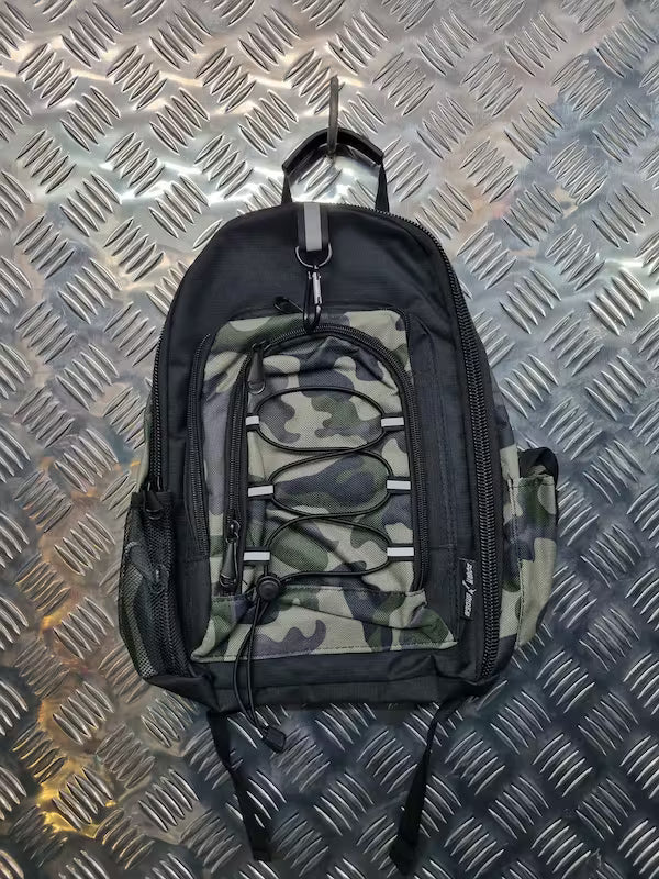 Camouflage backpack on a metallic surface
