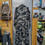 Camouflage snowsuit hanging on a display rack in a store setting