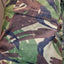 Camouflage-patterned fabric with visible wear and tear