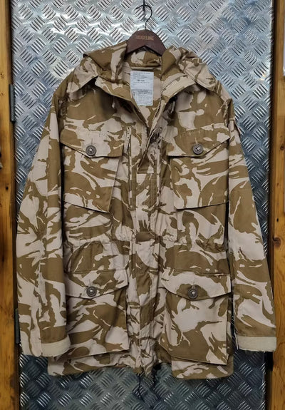 Camouflage jacket on a hanger against a metallic background