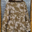 Camouflage-patterned jacket on a hanger against a metallic background