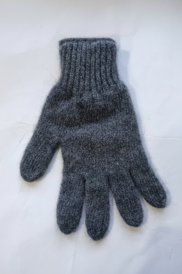 Gray knitted glove on a white background