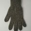 Gray knitted glove on a light gray background