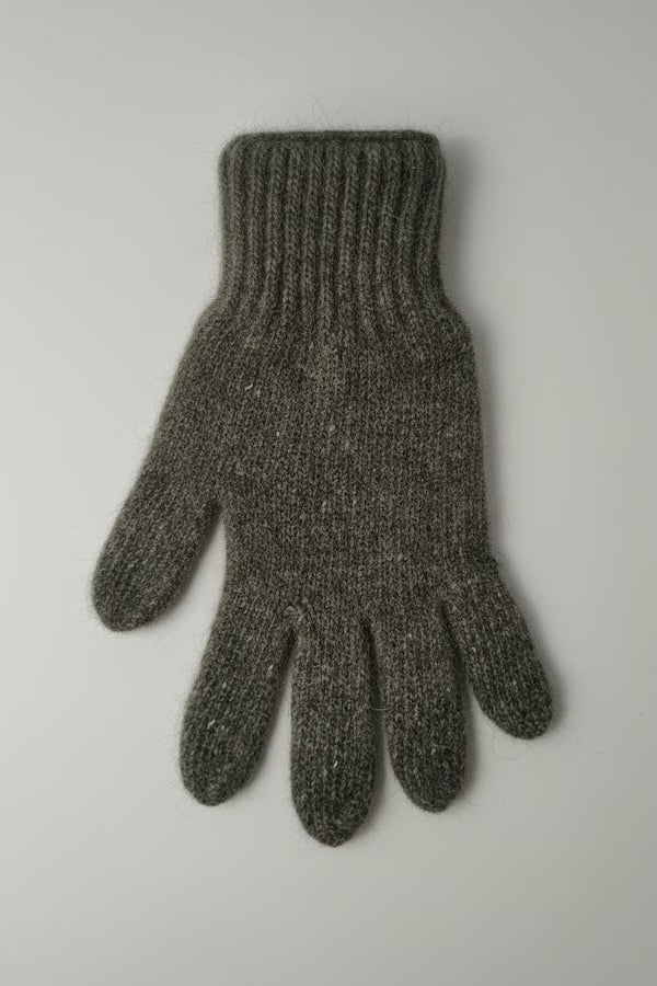 Gray knitted glove on a light gray background