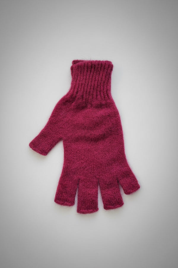 Red knitted glove on a light gray background