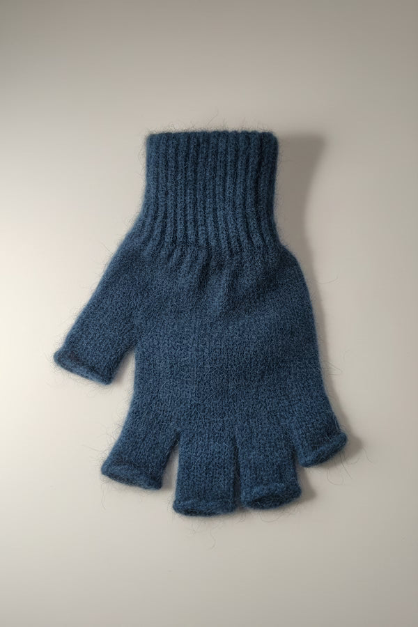Blue knitted fingerless glove on a light gray background