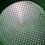 Close-up of a green plastic basket with a grid pattern