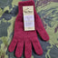 Red glove with a label on a patterned fabric background