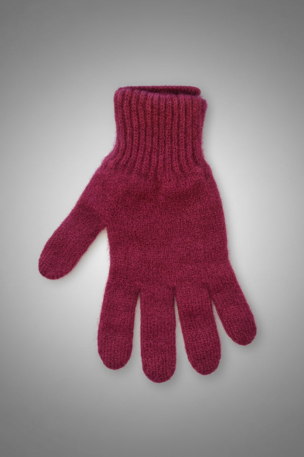 Red knitted glove on a gray background