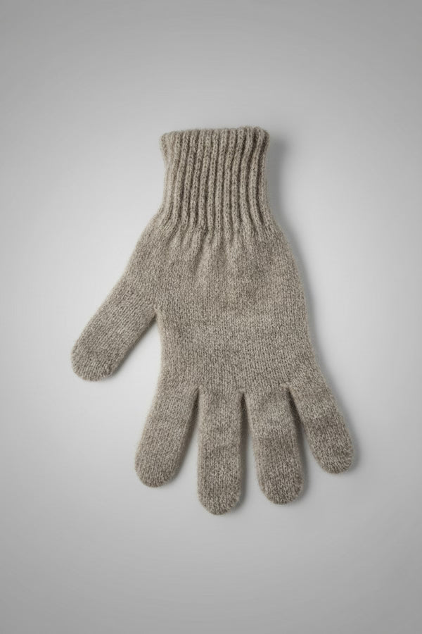 Knitted gray glove on a light gray background