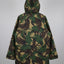 A hooded camouflage jacket shown from the back, featuring an all-over abstract leaf-like pattern in green, brown, and tan, photographed against a neutral gray background.