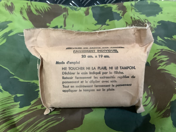 Fabric bandage package with text on a camouflage background