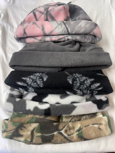 Stack of camouflage-patterned beanies on a white background