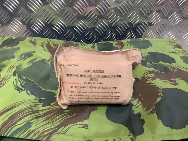 Vintage military dressing pad on a camouflage surface